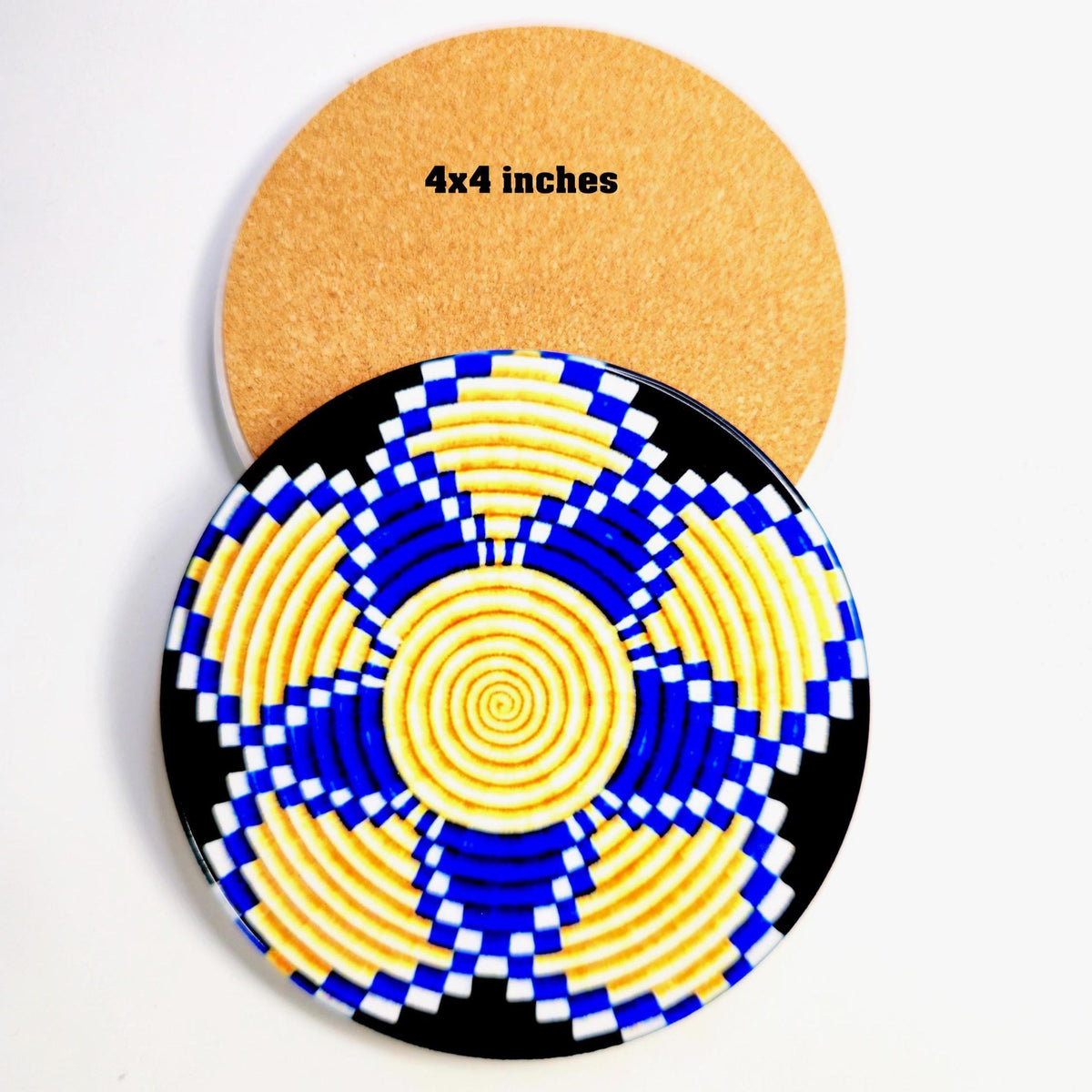 Two round coasters on a white background, showing both the patterned front and the natural cork backing. The front coaster features a blue, yellow, and black geometric spiral pattern, and the top coaster shows the tan cork backing with the text '4x4 inches'.
