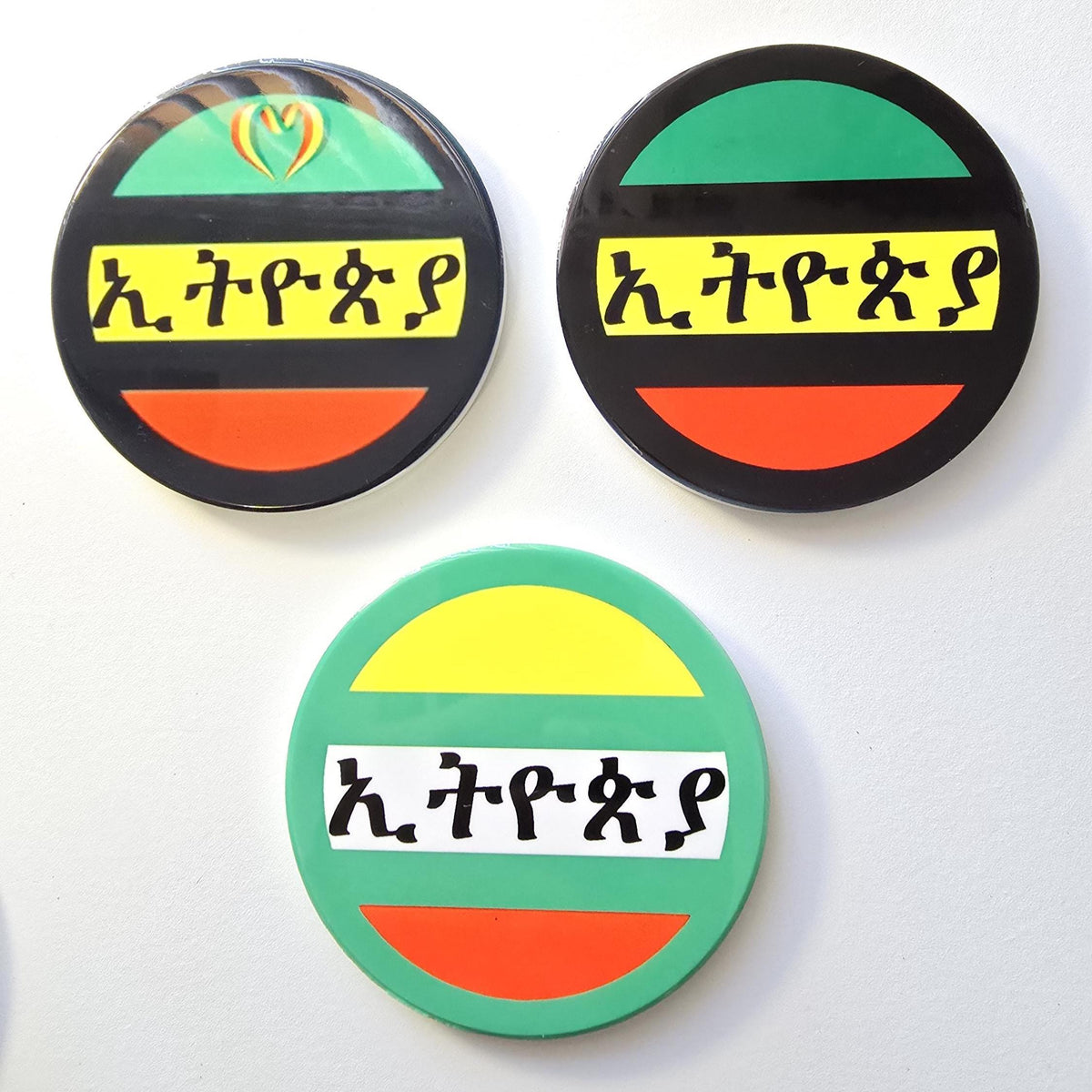 Three circular stickers with the Ethiopian flag design and Amharic script, displayed on a plain white background.