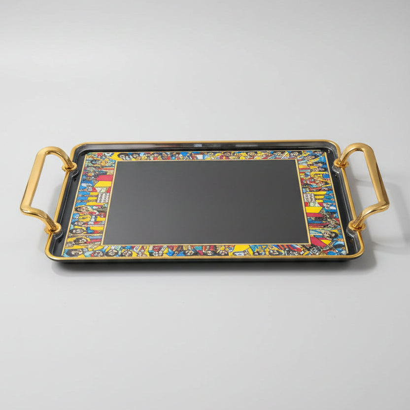 A rectangular decorative tray with gold handles and a colorful cartoon border, shown on a black marble surface.