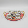 A ceramic coffee or tea set arranged on a round decorative tray with gold handles. The set includes a teapot, sugar bowl, and four matching cups and saucers, all decorated with a colorful illustrated border.