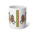 A white ceramic mug featuring a printed design of two lions facing each other on either side of a vertical green, red, and yellow stripe, resembling the flag of Eritrea.