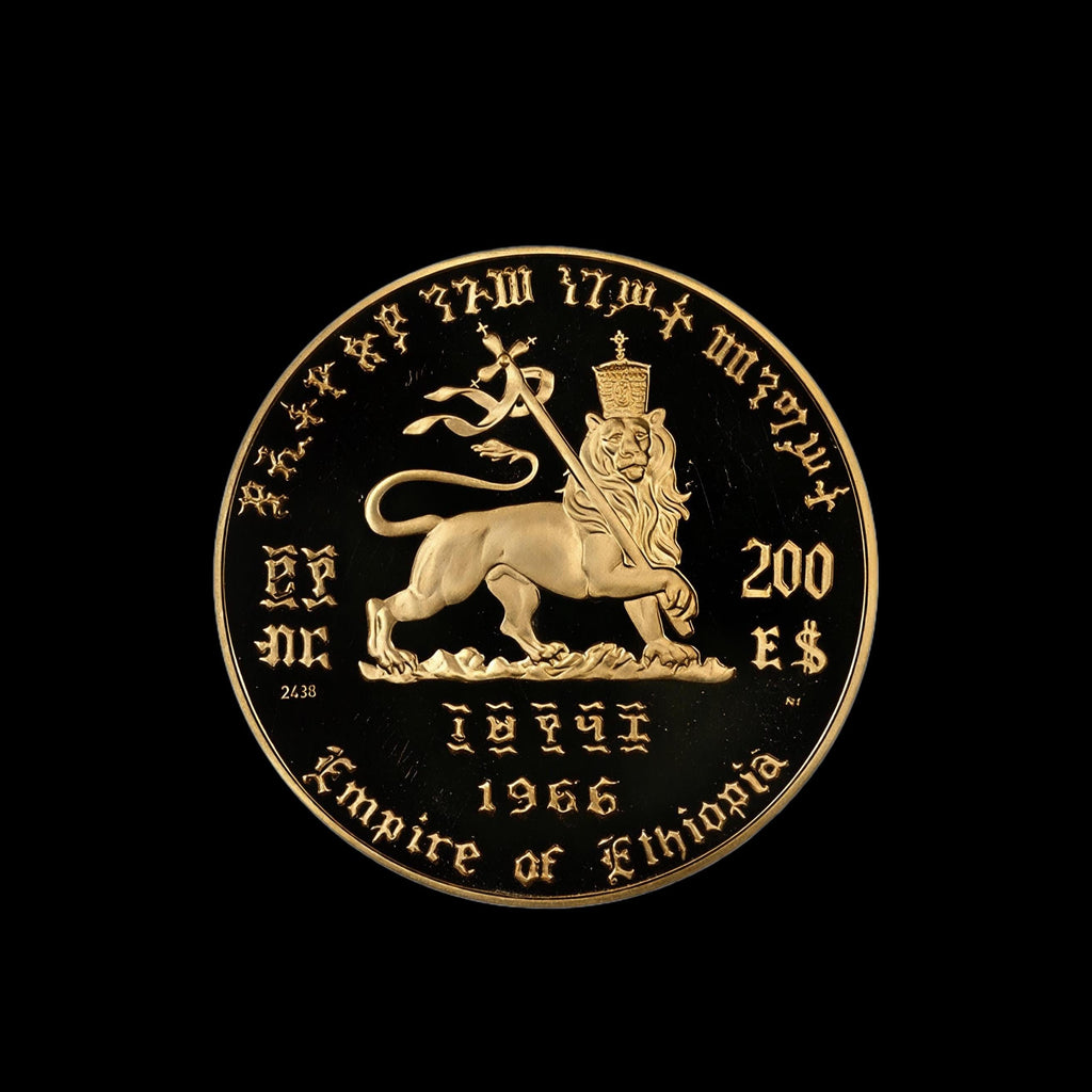 A round gold-colored commemorative coin for the Empire of Ethiopia, featuring a lion rampant and inscriptions, shown against a solid black background.
